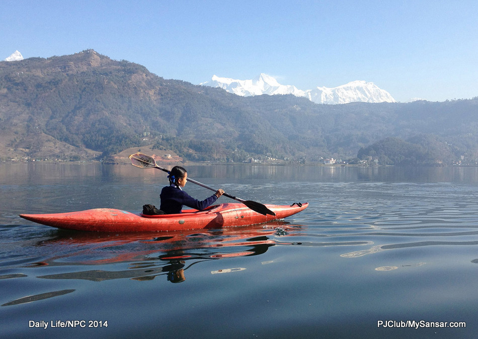 Rowing to and fro from school on a kayak is a daily routine for this young girl from Anadu near Phewa Taal. Photo: Purna Chandra Neupane 