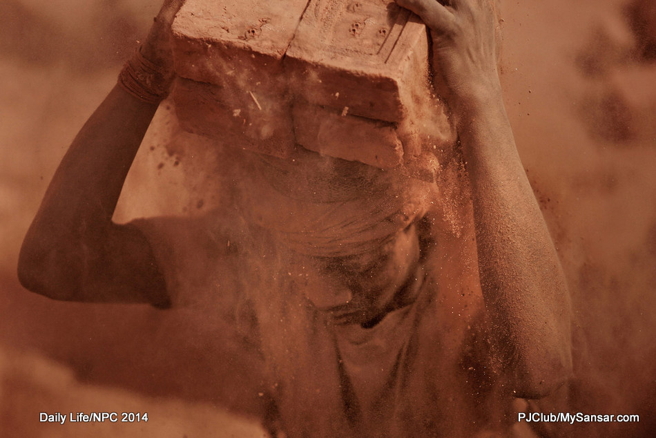 JURY MENTION | DAILY LIFE A brick kiln laborer works in extreme conditions while loading a truck at Champi, Patan. Most of these laborers are from Terai. Photo: Sampurna Lal Manandhar 