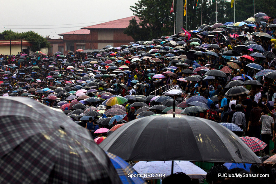 Football fans take shelter from the rain as they watch the final match of the Under 16 SAFF Championship between Nepal and India in Dasarath Rangasala. Photo: Surya Sunuwar 