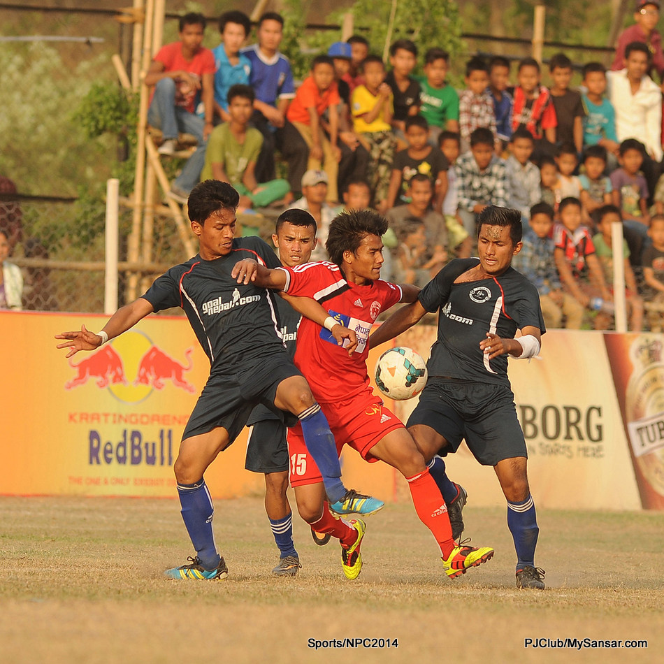 ANFA Dharan (black) and Nepal Police Club’s players struggle for the possession of the ball during their match in the 16th Budha Subba Gold Cup hosted by ANFA Dharan. Photo: Yatra Thulung Rai 