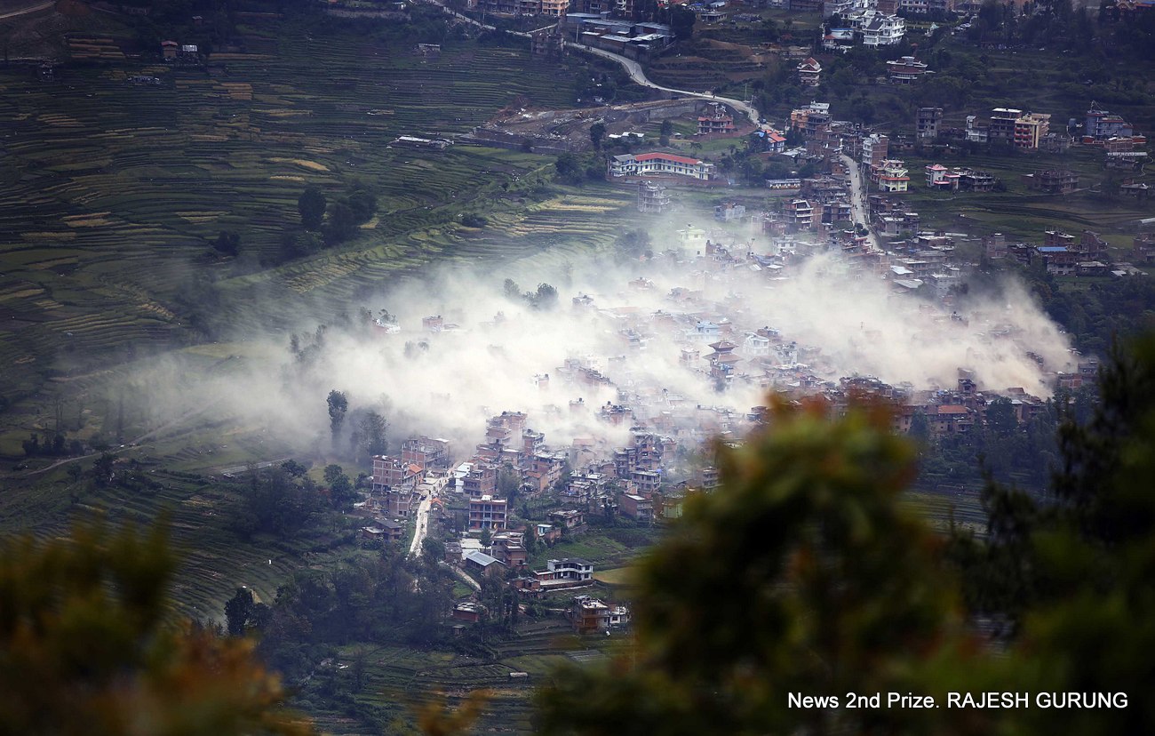 Smoke and dust billow over the sky in Khokana village of Lalitpur district a couple of minutes after Nepal was hit by a magnitude 7.6 earthquake on Saturday, April 25, 2015. The earthquake killed more than 9,000 people, injured at least 23,000, wiped out 200,000 homes, 20,000 schools and destroyed more than 700 monuments.