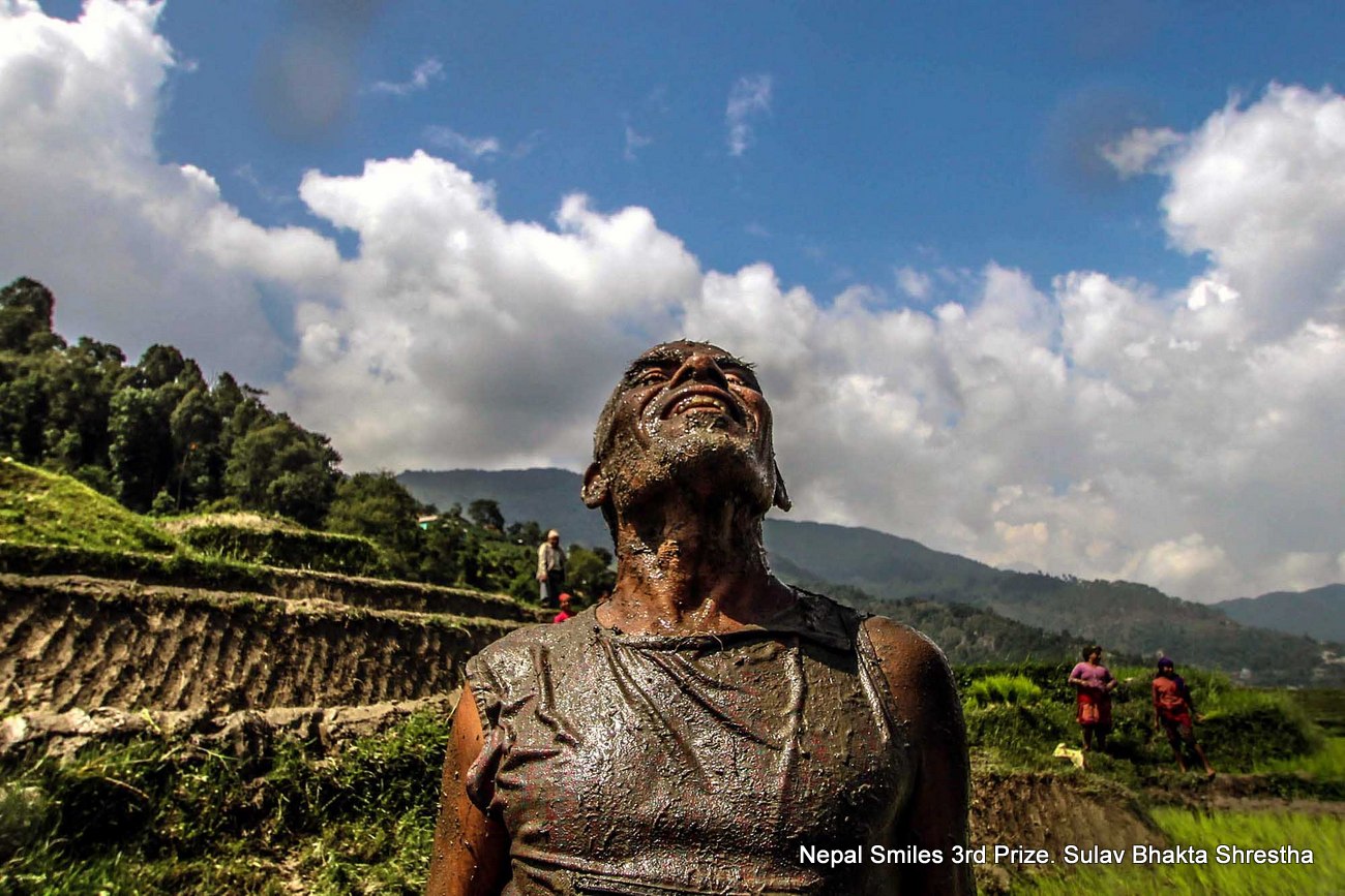 An elderly  man has a jovial  moment and relishes during a paddy plantation at jitpur fedi, kathmandu.