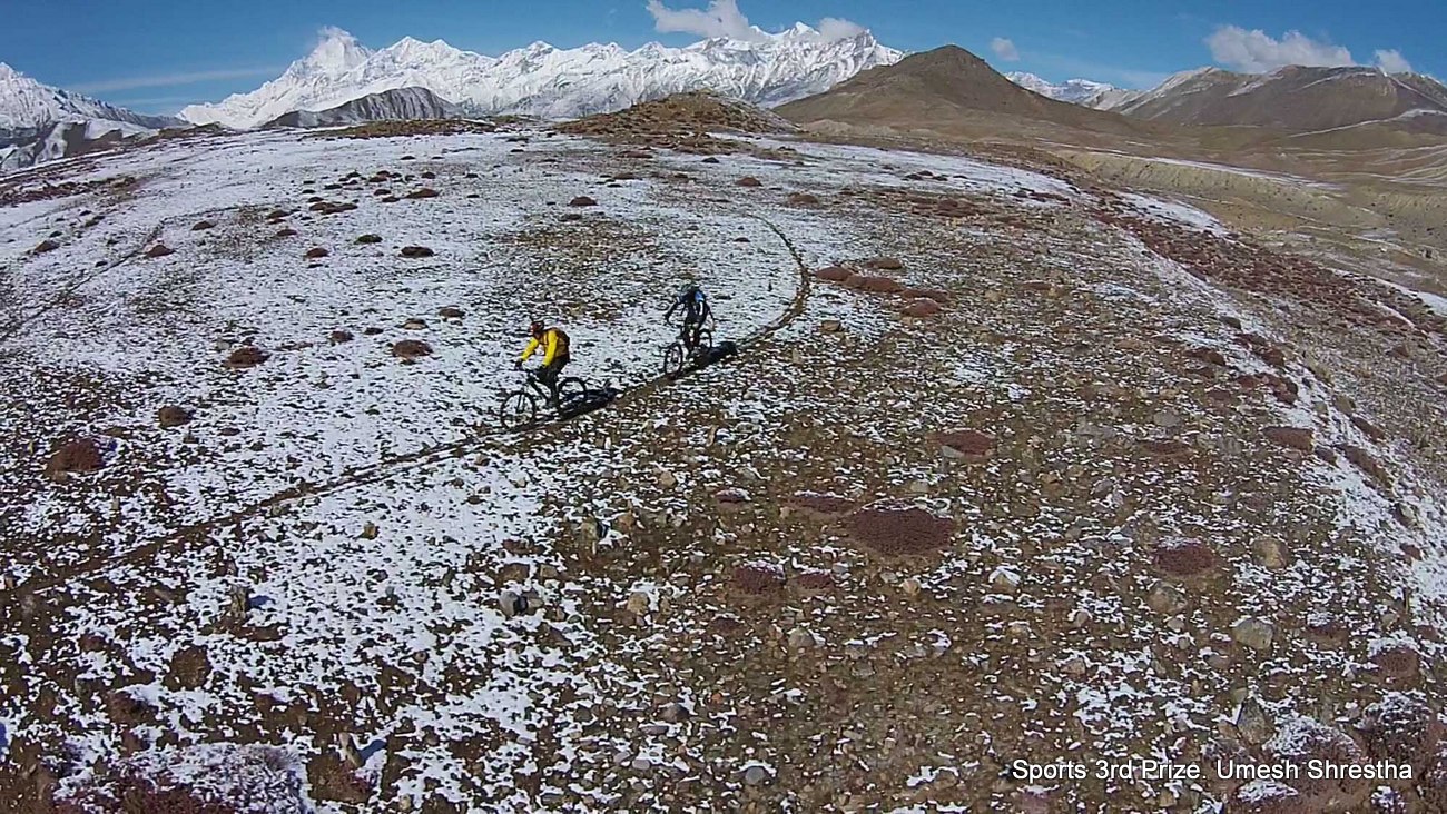 Bird's eye view of two mountain bikers in Muktinath, Mustang.