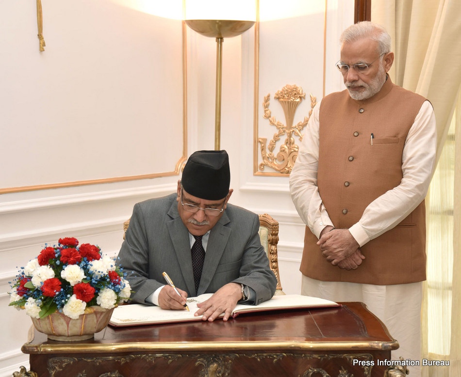 The Prime Minister of Nepal, Mr. Pushpa Kamal Dahal signing the visitor's book, at Hyderabad House, in New Delhi on September 16, 2016. The Prime Minister, Shri Narendra Modi is also seen.